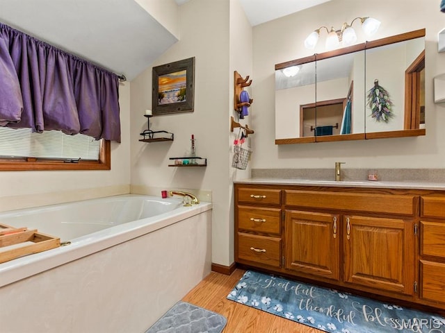 2700 Woods Way, Belleville, IL 62221 - bathroom with wood finished floors, a bath, vanity, and vaulted ceiling