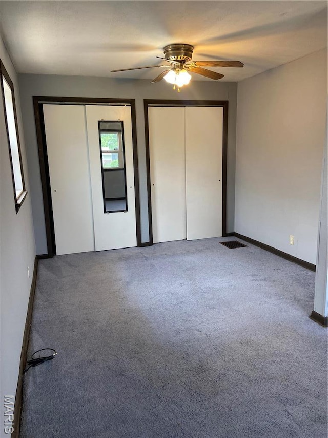 2326 Edwards St, Granite City, IL 62040 - unfurnished bedroom with two closets, carpet flooring, a ceiling fan, and baseboards