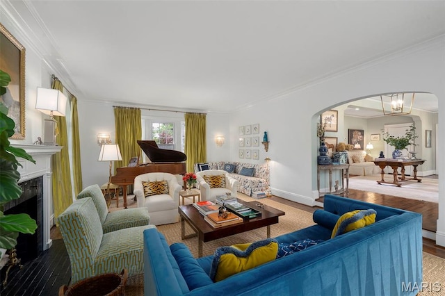 20 Picardy Ln, Ladue, MO 63124 - living room with arched walkways, crown molding, wood finished floors, baseboards, and a fireplace