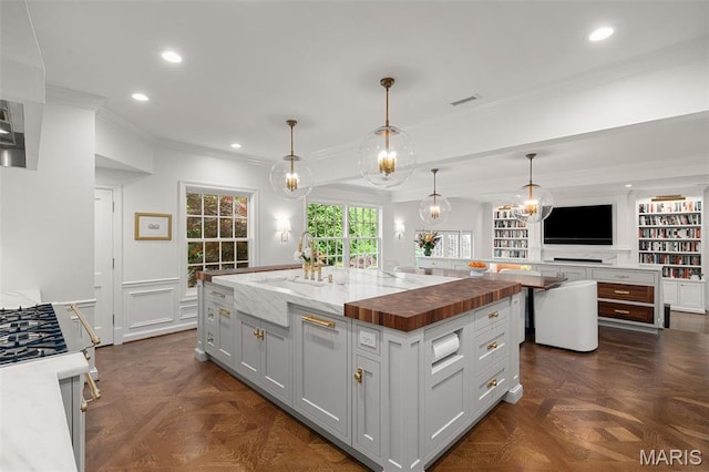 20 Picardy Ln, Ladue, MO 63124 - kitchen featuring a sink, a spacious island, range, wooden counters, and crown molding
