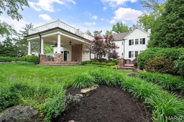 20 Picardy Ln, Ladue, MO 63124 - back of house with a balcony, a lawn, brick siding, and a porch