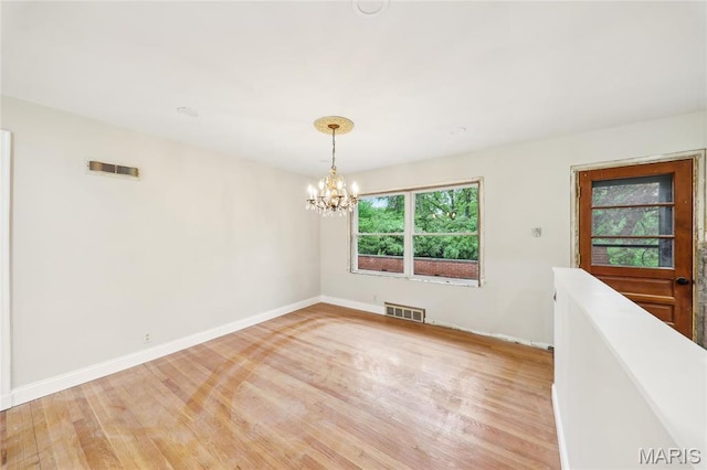 18 Spoede Hills Dr, Saint Louis, MO 63141 - unfurnished room with light wood-style flooring, a chandelier, and baseboards