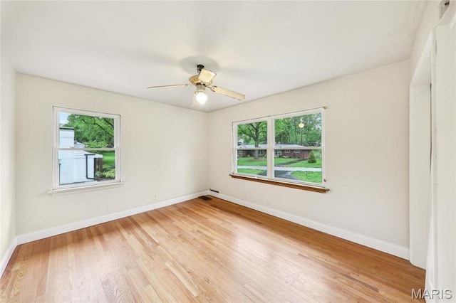 18 Spoede Hills Dr, Saint Louis, MO 63141 - spare room featuring plenty of natural light, baseboards, light wood-type flooring, and ceiling fan