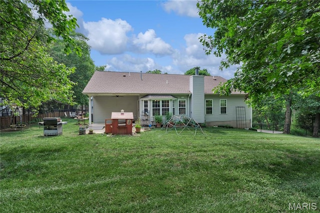 1587 Paradise Valley Dr, High Ridge, MO 63049 - back of property with a fenced backyard, a chimney, and a ceiling fan