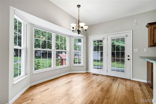 1587 Paradise Valley Dr, High Ridge, MO 63049 - unfurnished dining area with a chandelier and light wood finished floors