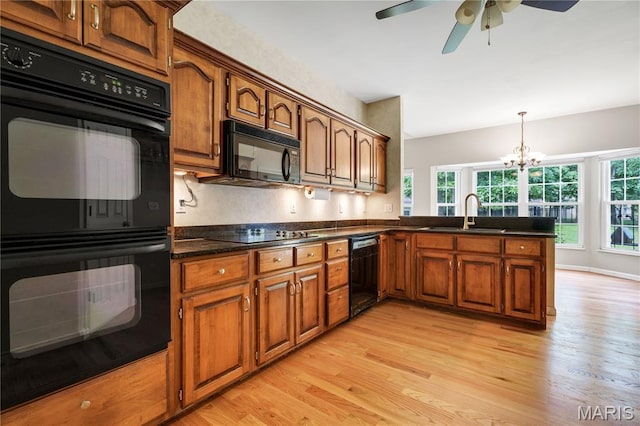 1587 Paradise Valley Dr, High Ridge, MO 63049 - kitchen with black appliances, light wood finished floors, ceiling fan, dark countertops, and brown cabinets