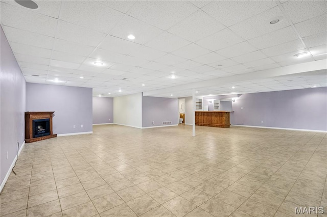 1587 Paradise Valley Dr, High Ridge, MO 63049 - unfurnished living room with a paneled ceiling, a fireplace with raised hearth, and bar