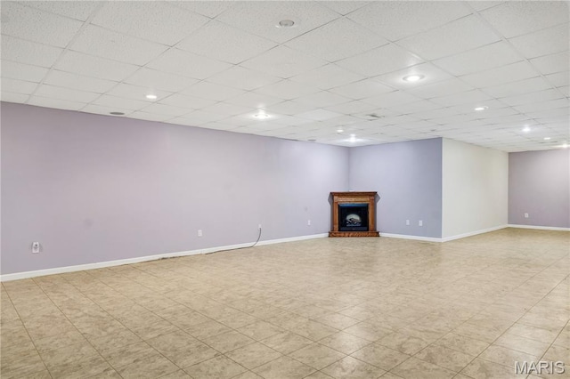 1587 Paradise Valley Dr, High Ridge, MO 63049 - unfurnished living room with a fireplace with raised hearth, a paneled ceiling, and recessed lighting