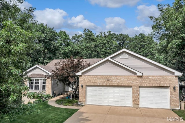1587 Paradise Valley Dr, High Ridge, MO 63049 - ranch-style house with brick siding, concrete driveway, a front yard, and an attached garage