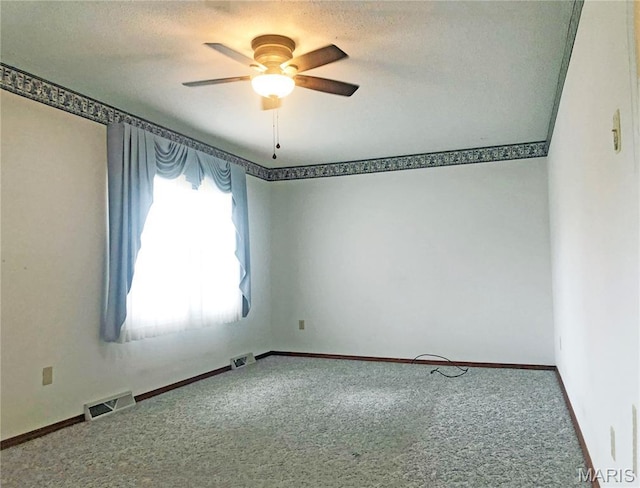 603 W Bloomfield Ave, Bloomfield, MO 63825 - carpeted spare room featuring ceiling fan, baseboards, and a textured ceiling