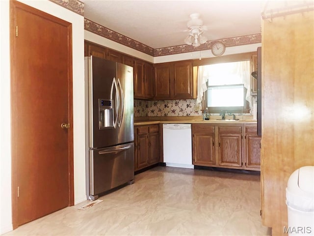 603 W Bloomfield Ave, Bloomfield, MO 63825 - kitchen with stainless steel fridge, white dishwasher, ceiling fan, and a sink