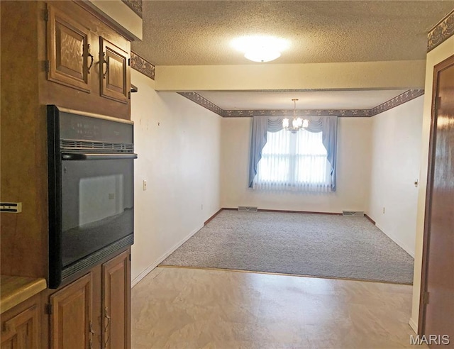 603 W Bloomfield Ave, Bloomfield, MO 63825 - kitchen featuring oven, light carpet, a textured ceiling, brown cabinetry, and baseboards