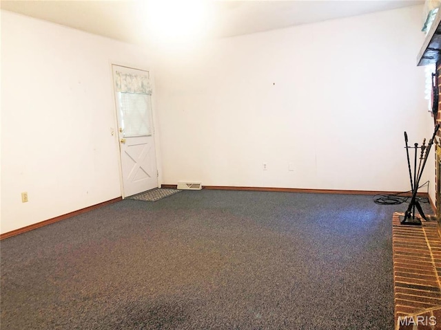 603 W Bloomfield Ave, Bloomfield, MO 63825 - empty room with dark colored carpet and baseboards