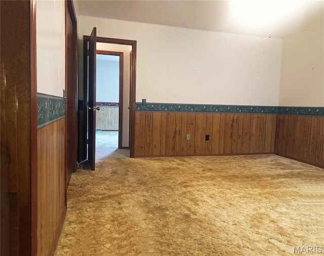 603 W Bloomfield Ave, Bloomfield, MO 63825 - carpeted empty room with wood walls and wainscoting