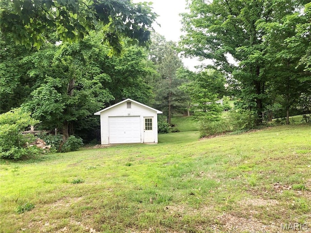 603 W Bloomfield Ave, Bloomfield, MO 63825 - view of green lawn featuring an outbuilding and a garage