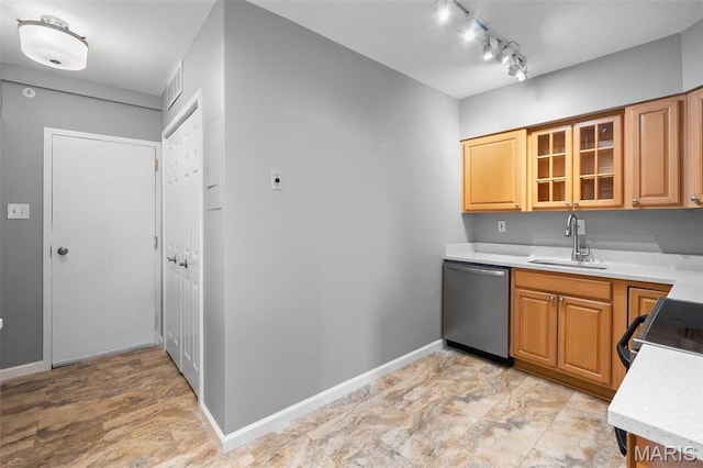 900 S Hanley Rd Unit 7B, Saint Louis, MO 63105 - kitchen with stainless steel dishwasher, a sink, light countertops, baseboards, and glass insert cabinets