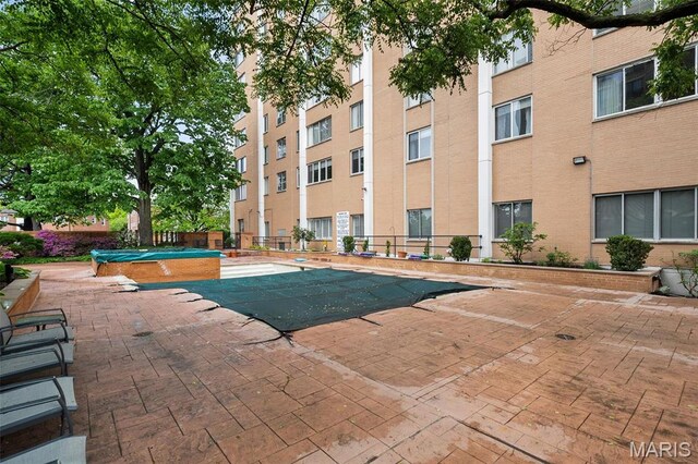 900 S Hanley Rd Unit 7B, Saint Louis, MO 63105 - view of swimming pool with a patio and fence