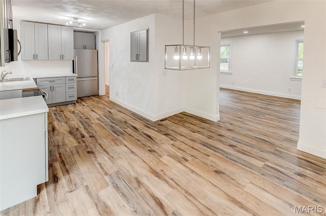 14 Carson Dr, Belleville, IL 62223 - kitchen with stainless steel appliances, gray cabinetry, light countertops, and light wood finished floors