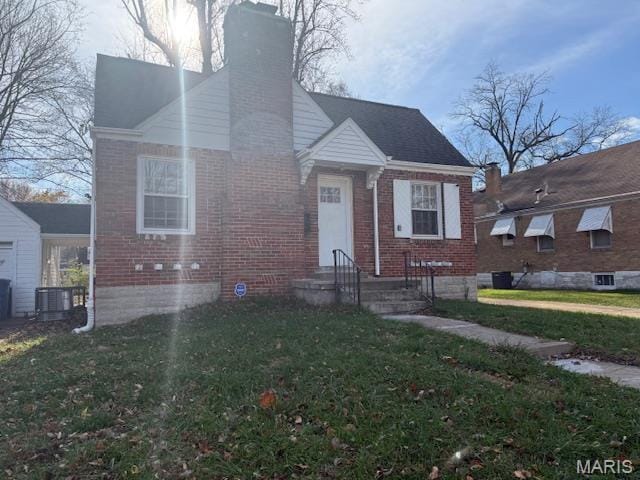 38 Lee Ave, Saint Louis, MO 63135 - bungalow-style house with a chimney, brick siding, a front yard, and central AC unit