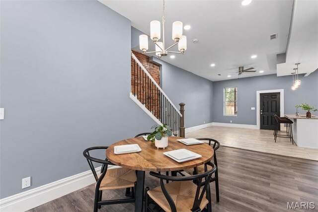 3244 Michigan Ave, Saint Louis, MO 63118 - dining space with stairway, wood finished floors, baseboards, recessed lighting, and a chandelier