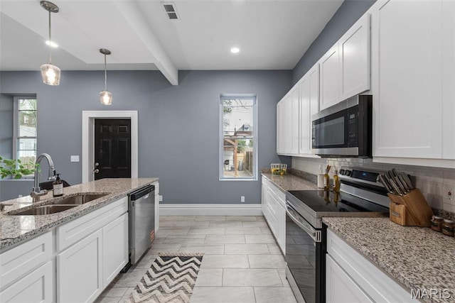 3244 Michigan Ave, Saint Louis, MO 63118 - kitchen featuring appliances with stainless steel finishes, a sink, white cabinets, recessed lighting, and beam ceiling
