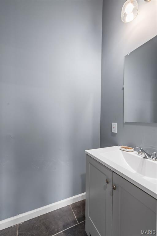 3244 Michigan Ave, Saint Louis, MO 63118 - bathroom with vanity, baseboards, and tile patterned floors