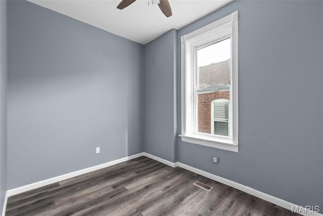 3244 Michigan Ave, Saint Louis, MO 63118 - spare room featuring a ceiling fan, dark wood-type flooring, and baseboards