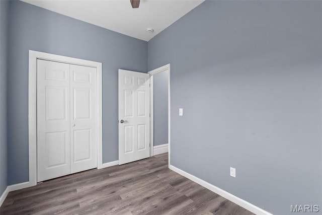 3244 Michigan Ave, Saint Louis, MO 63118 - unfurnished bedroom featuring a closet, baseboards, and wood finished floors
