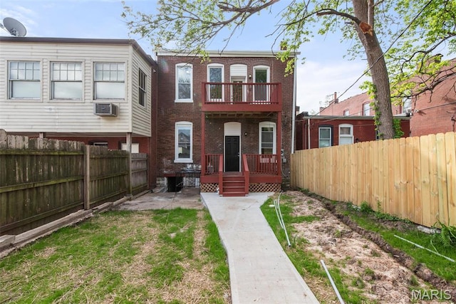 3244 Michigan Ave, Saint Louis, MO 63118 - rear view of house with a fenced backyard, brick siding, a wooden deck, a patio, and a balcony