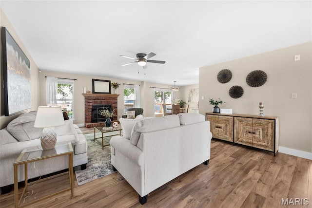 2222 Harborside Dr, Ofallon, MO 63368 - living area featuring healthy amount of natural light, ceiling fan, and wood finished floors