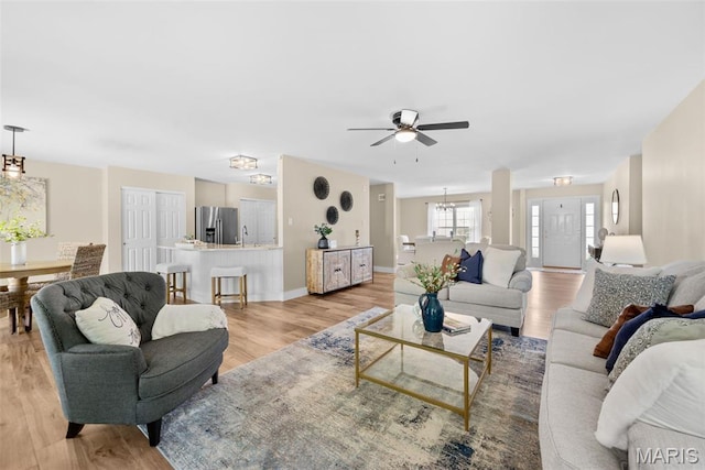 2222 Harborside Dr, Ofallon, MO 63368 - living area with a ceiling fan, light wood-type flooring, and baseboards