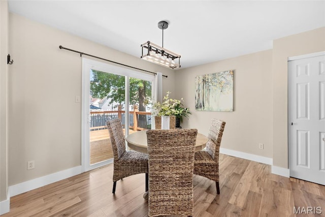 2222 Harborside Dr, Ofallon, MO 63368 - dining space featuring baseboards and light wood-style flooring