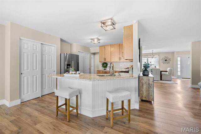 2222 Harborside Dr, Ofallon, MO 63368 - kitchen with high end fridge, a sink, a peninsula, and a breakfast bar
