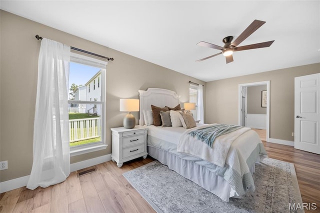 2222 Harborside Dr, Ofallon, MO 63368 - bedroom featuring light wood-style floors, baseboards, ceiling fan, and ensuite bath