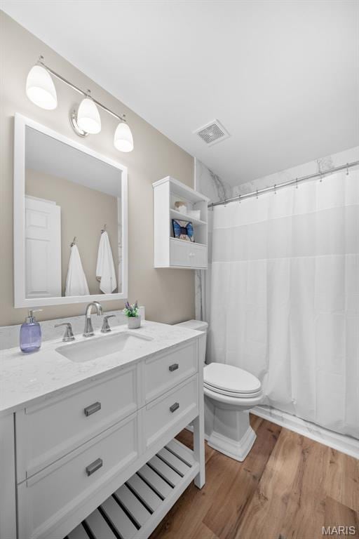 2222 Harborside Dr, Ofallon, MO 63368 - bathroom with vanity, wood finished floors, toilet, and a shower with curtain