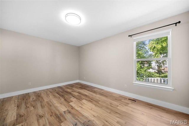 2222 Harborside Dr, Ofallon, MO 63368 - spare room featuring light wood-style flooring and baseboards