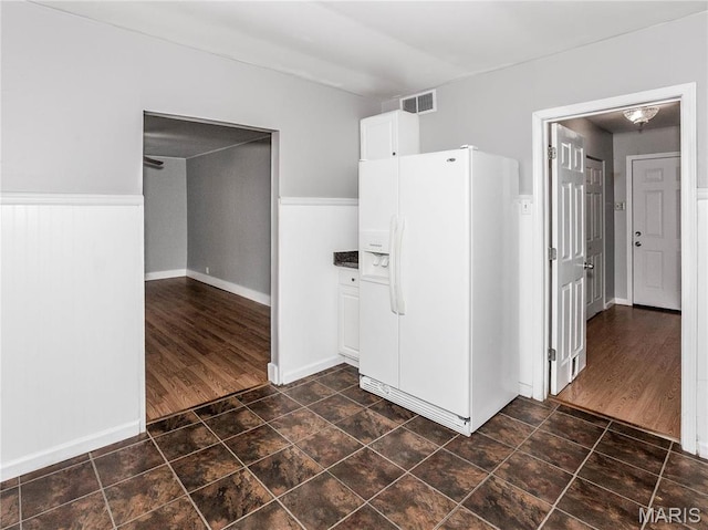 123 E Charter St, Troy, IL 62294 - kitchen featuring white fridge with ice dispenser, white cabinetry, and baseboards
