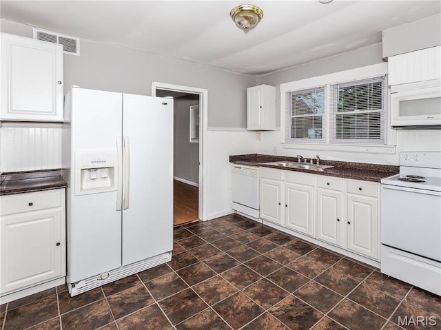 123 E Charter St, Troy, IL 62294 - kitchen featuring white appliances, dark countertops, a sink, and white cabinetry
