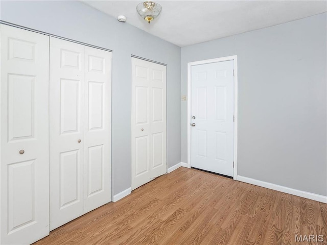 123 E Charter St, Troy, IL 62294 - unfurnished bedroom with light wood-type flooring, baseboards, and a closet
