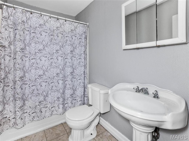 123 E Charter St, Troy, IL 62294 - bathroom with tile patterned flooring, toilet, baseboards, and a sink