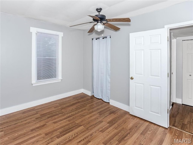 123 E Charter St, Troy, IL 62294 - unfurnished bedroom with baseboards, wood finished floors, and a ceiling fan