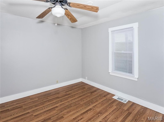 123 E Charter St, Troy, IL 62294 - unfurnished room featuring dark wood-style floors, baseboards, and a ceiling fan