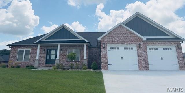 242 Orange Bowl Dr, Cape Girardeau, MO 63701 - craftsman inspired home with concrete driveway, an attached garage, brick siding, and a front yard