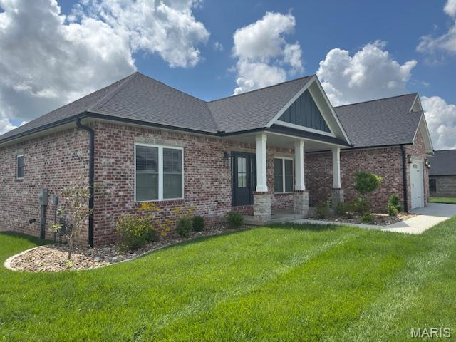 242 Orange Bowl Dr, Cape Girardeau, MO 63701 - craftsman-style home with brick siding, a front yard, a shingled roof, a porch, and an attached garage