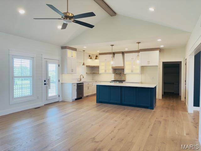 242 Orange Bowl Dr, Cape Girardeau, MO 63701 - kitchen featuring wall chimney range hood, dishwasher, white cabinets, a sink, and light countertops