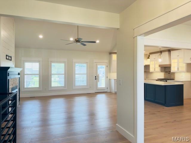 242 Orange Bowl Dr, Cape Girardeau, MO 63701 - unfurnished living room featuring light wood-style flooring, ceiling fan, plenty of natural light, and baseboards