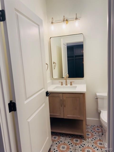 242 Orange Bowl Dr, Cape Girardeau, MO 63701 - half bathroom with toilet, vanity, tile patterned floors, and baseboards