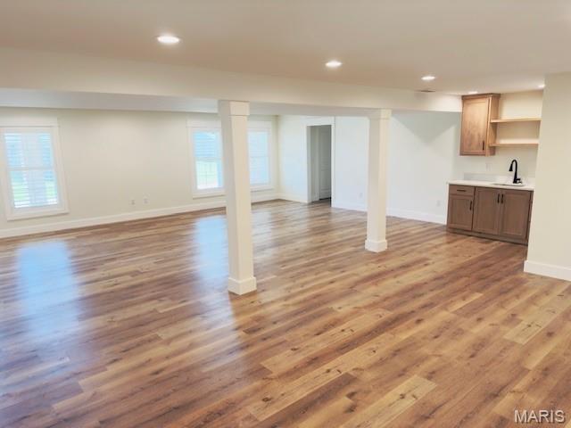 242 Orange Bowl Dr, Cape Girardeau, MO 63701 - basement featuring a sink, recessed lighting, light wood-type flooring, and baseboards