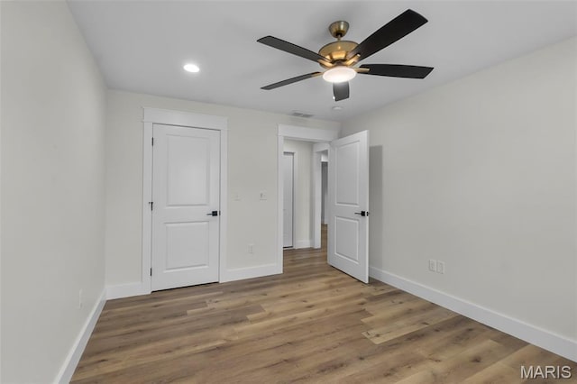 242 Orange Bowl Dr, Cape Girardeau, MO 63701 - unfurnished bedroom with baseboards, wood finished floors, recessed lighting, and ceiling fan