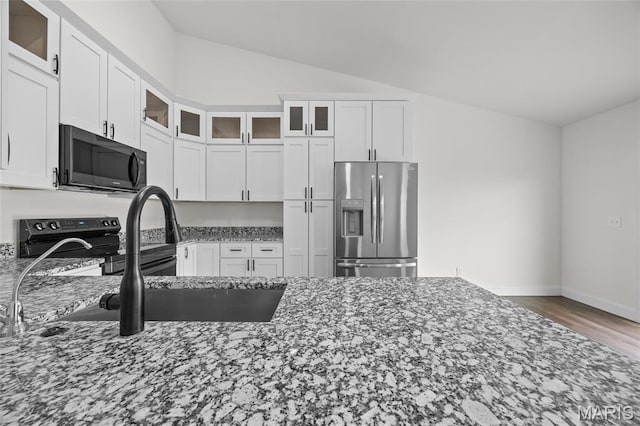 764 Red Clover Dr, Cedar Hill, MO 63016 - kitchen with stainless steel fridge, electric range, dark stone countertops, lofted ceiling, and white cabinets
